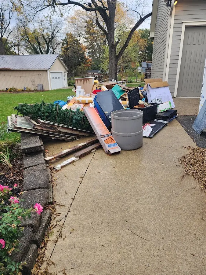 Dumpster being loaded with debris for Roofing Dumpster Rental in Oak Hills